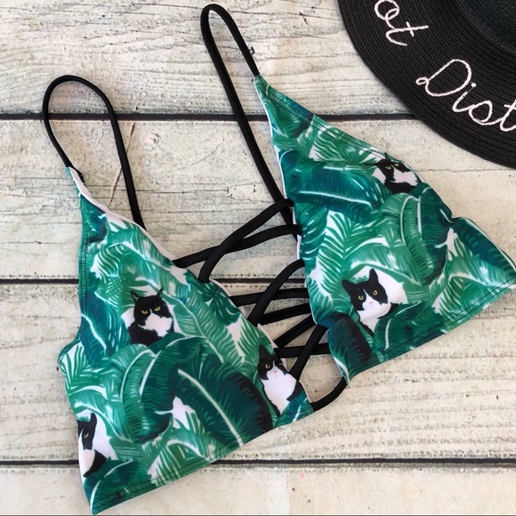 white swimsuit with green leaves